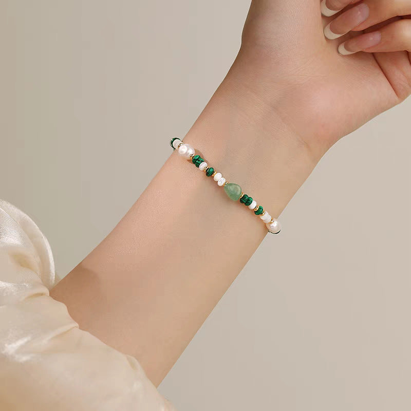 Malachite aventurine and pearl bracelet worn on the wrist