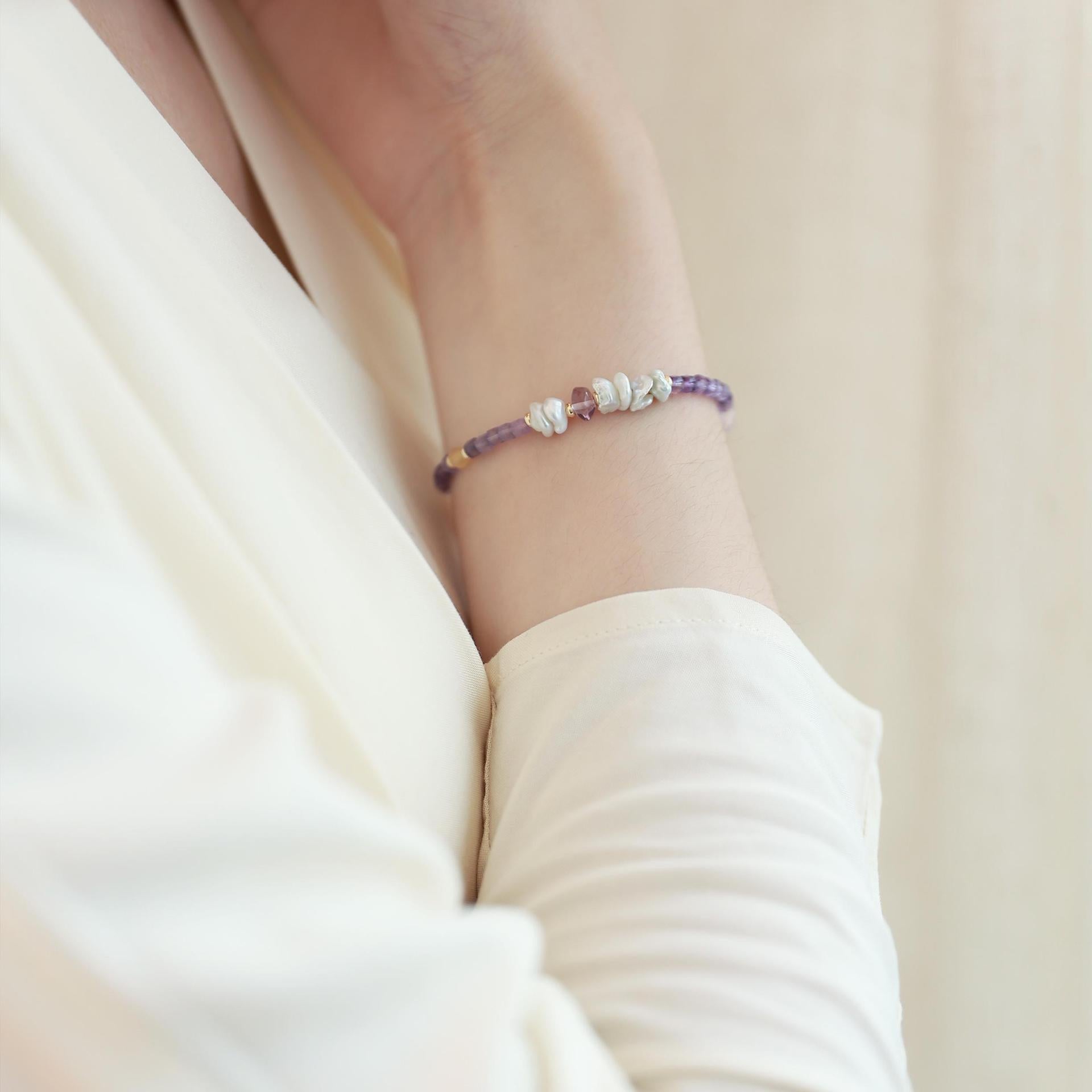 Amethyst and freshwater pearl bracelet worn on the wrist