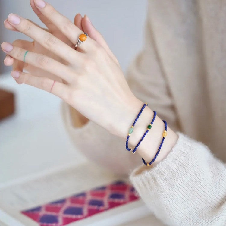 Lapis lazuli and red agate wisdom necklace styled as a bracelet
