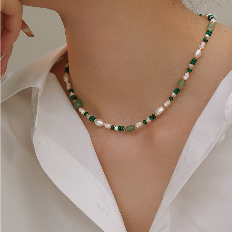Malachite aventurine and pearl necklace worn at the collarbone