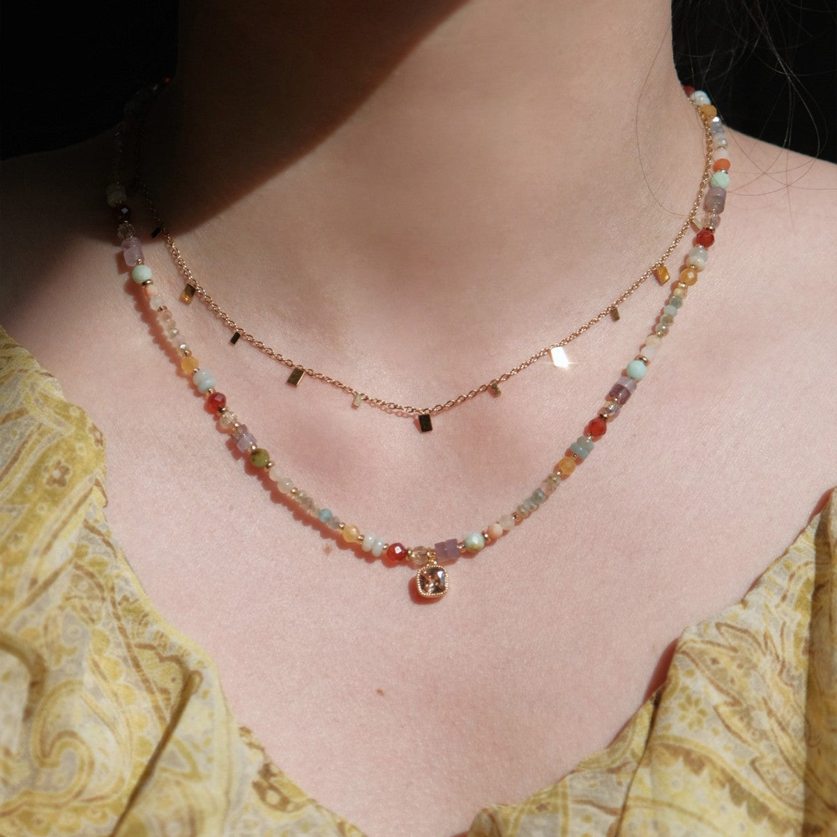 Rainbow crystal necklace styled in a layered look