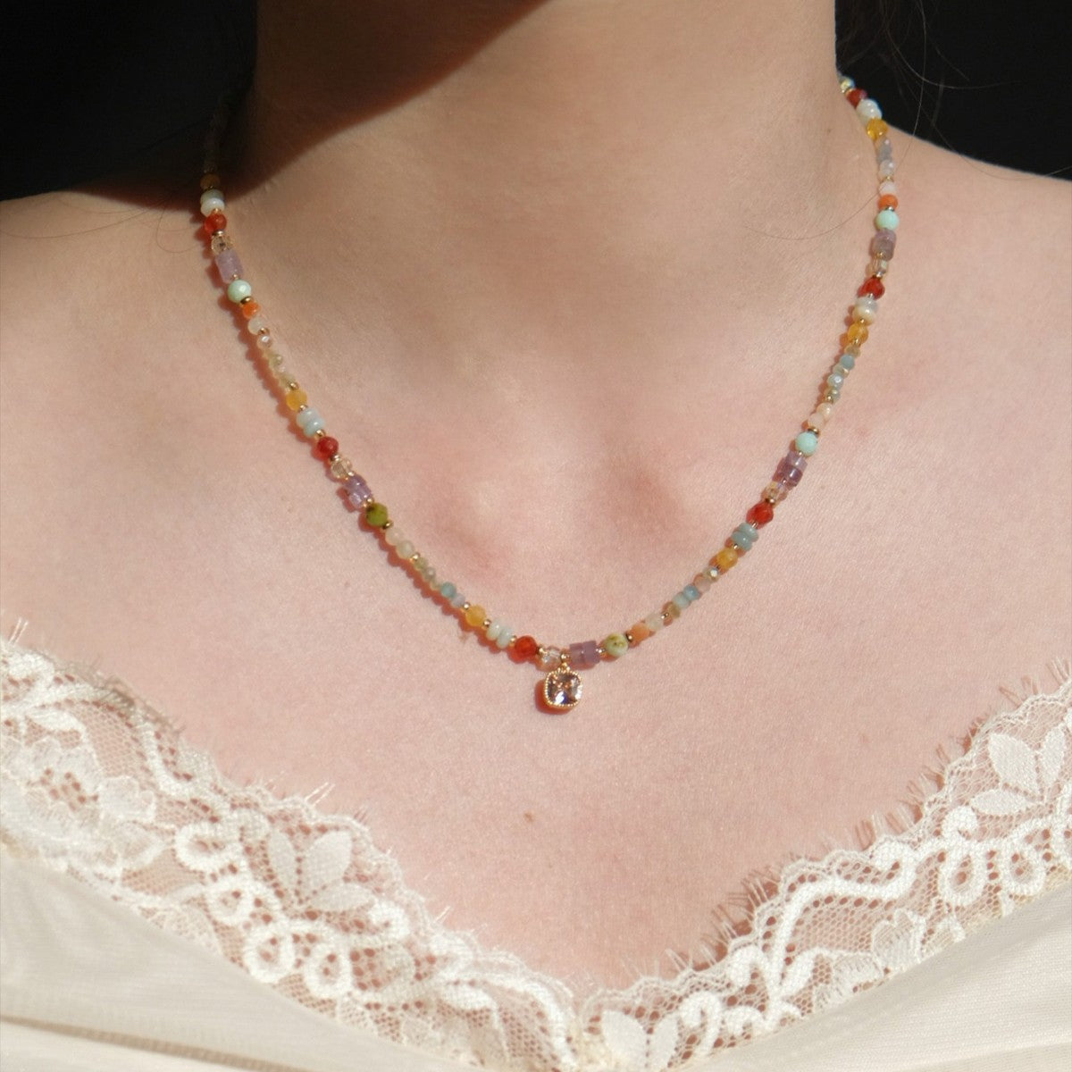 Rainbow crystal intention necklace worn at the collarbone