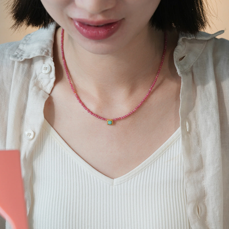 Rhodochrosite and turquoise heart necklace worn as a delicate layering piece